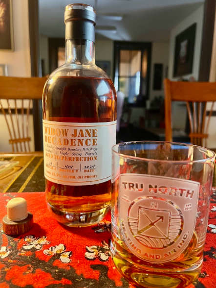Bottle of Widow Jane Decadence bourbon with a Tru North glass